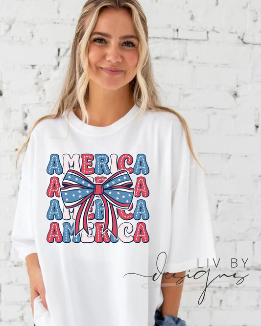 “White t-shirt with America bow DTF print modeled in front of brick wall”