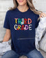 Comfort Colors Third Grade teacher shirt in navy with vibrant school supply graphics