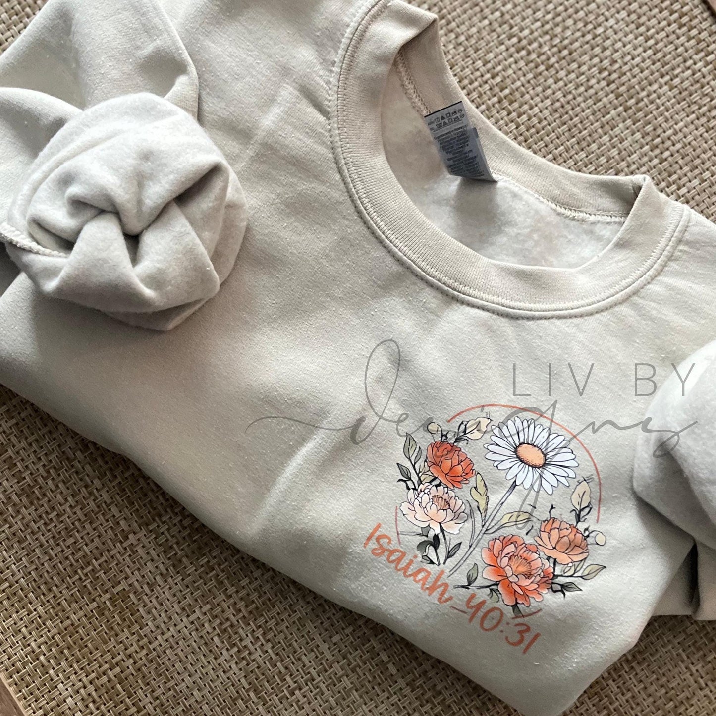 Christian faith-based crewneck sweatshirt featuring floral artwork and the phrase “In the Waiting, God Is Working” inspired by Isaiah 40:31, shown on a neutral Gildan Heavy Blend sweatshirt.