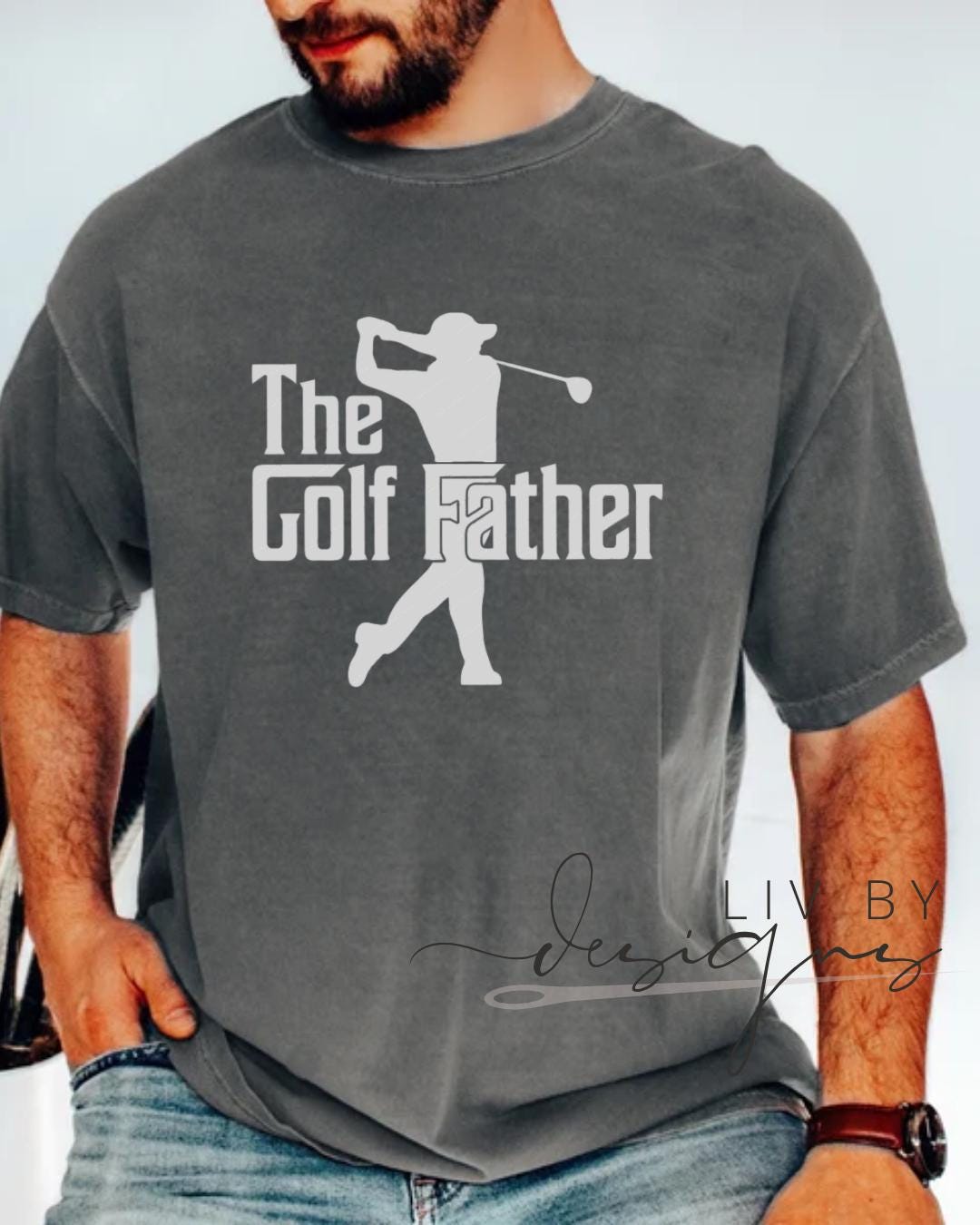 “Man wearing The GolfFather Comfort Colors t-shirt in pepper, hands in pockets” (etsy image id: 6915664970)
