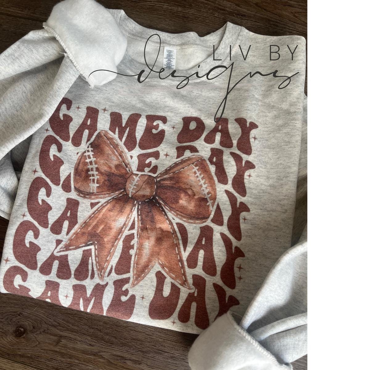 Cozy Gildan sweatshirt with Game Day text and football bow design (etsy image id: 7040283216)
