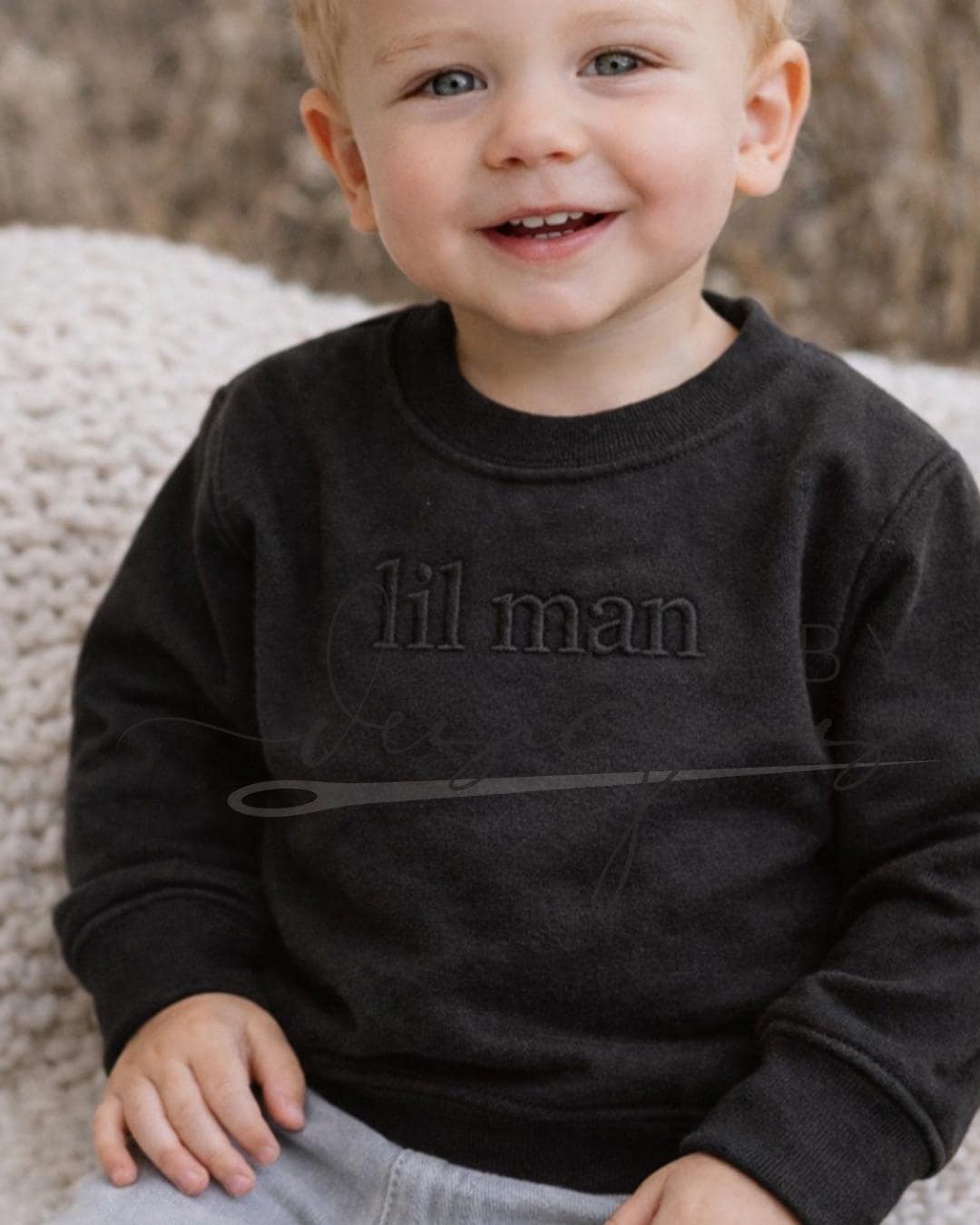 A toddler featuring an embroidered "lil man" on the front of his chest with a monochrome coloring thread (etsy image id: 7660006891)