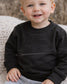 A toddler featuring an embroidered "lil man" on the front of his chest with a monochrome coloring thread (etsy image id: 7660006891)